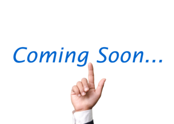 This is a picture of a man's hand pointing up the the words "Coming Soon." This spot is currently vacant.