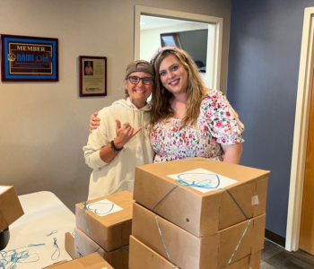 LOSS Team members smiling after boxing up cookies